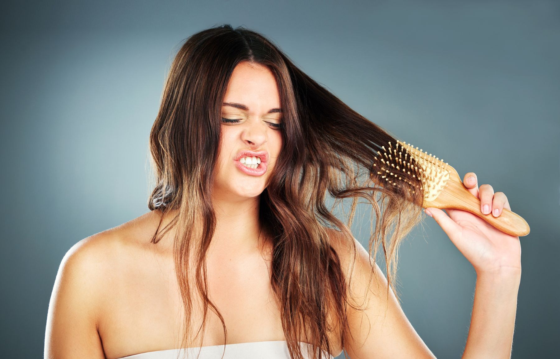 Woman brushing hair aggressively