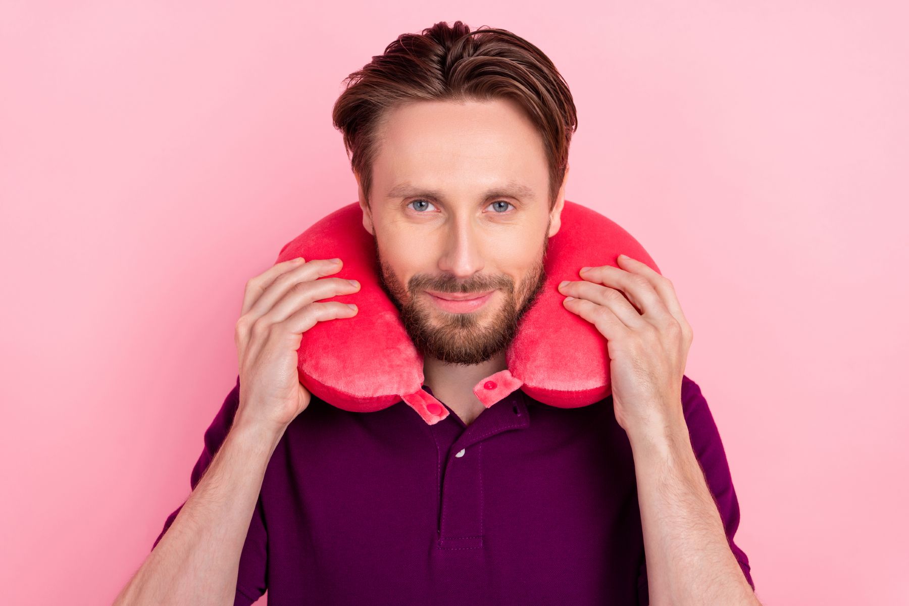Man wearing a neck pillow