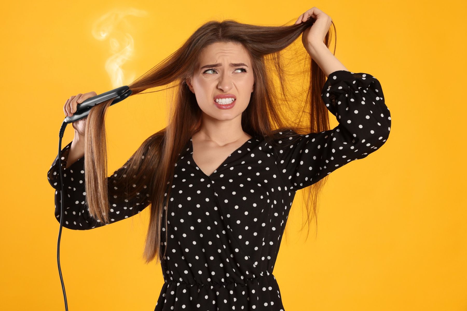 Woman heat-styling her hair