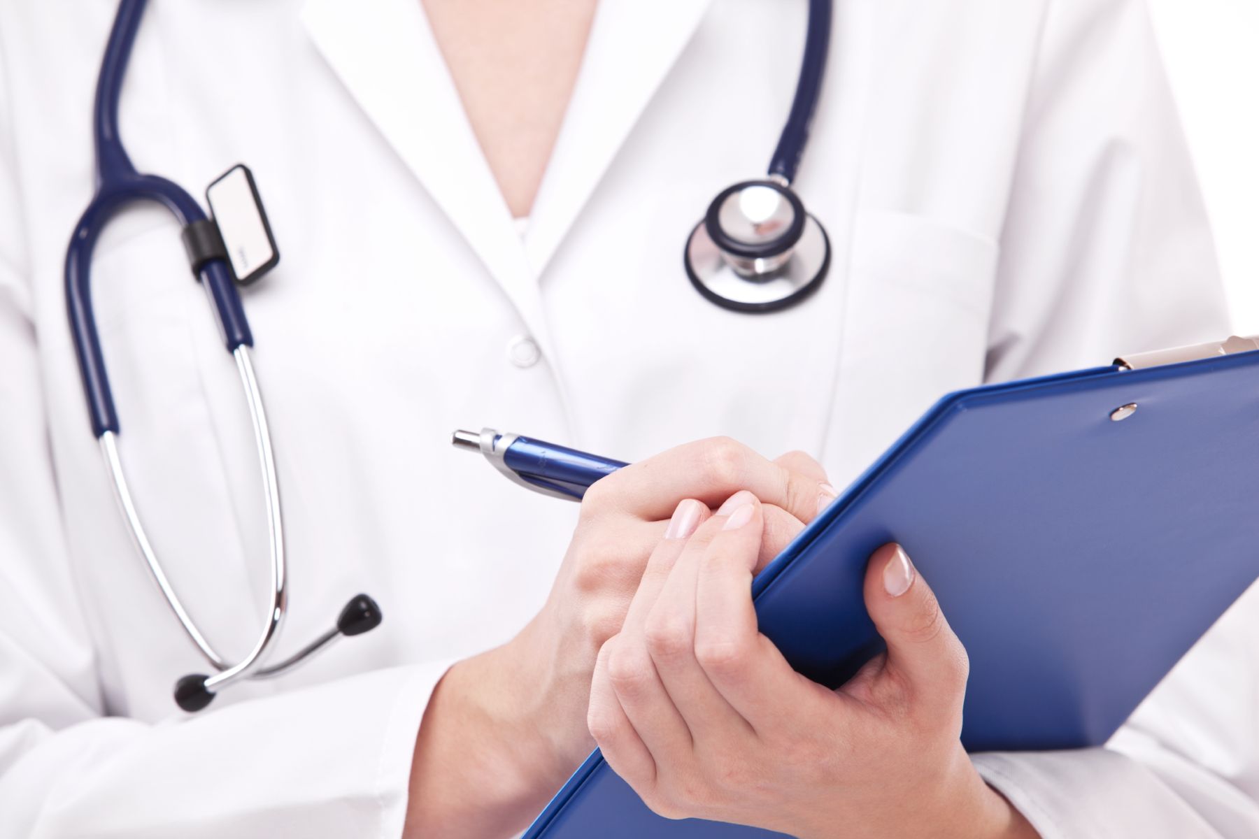 Doctor writing in chart