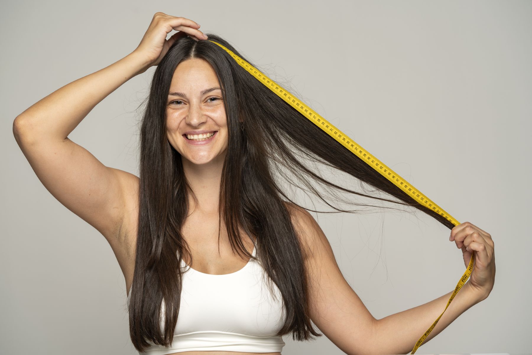 Woman measuring how fast her hair is growing