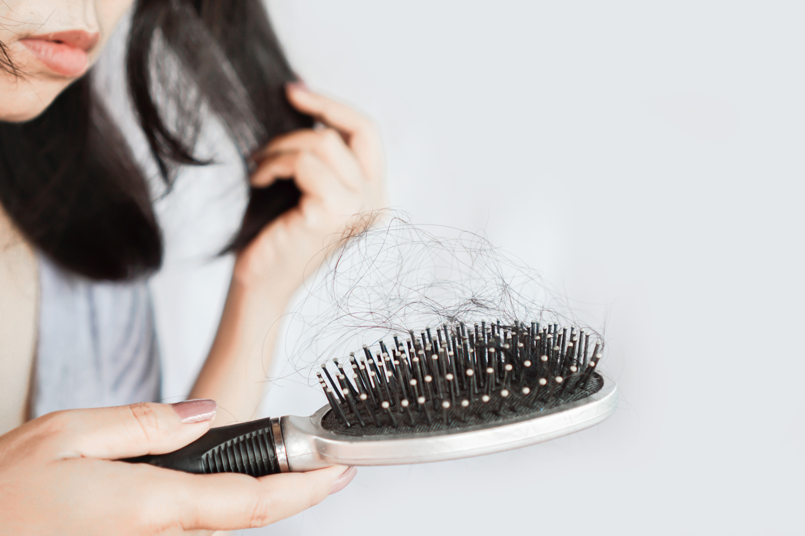 woman experiencing hair loss