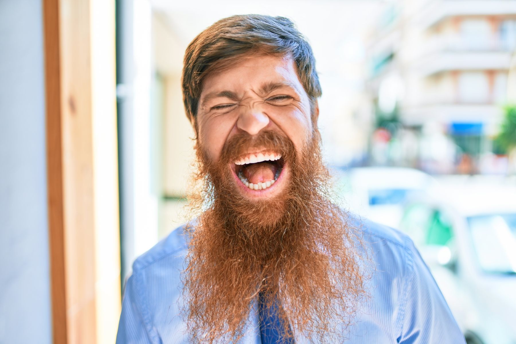Man with a sparse, uneven long beard