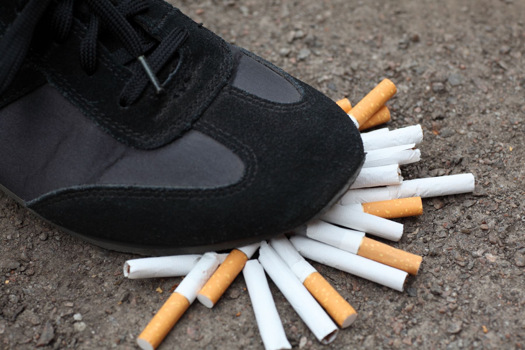 Stomping cigarettes to reduce or quit smoking