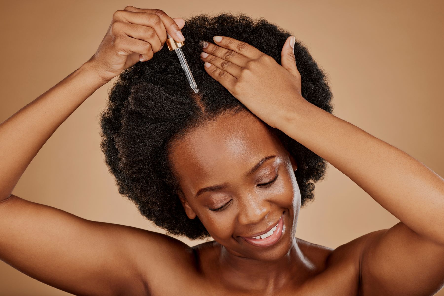 Woman applying rosemary hair oil