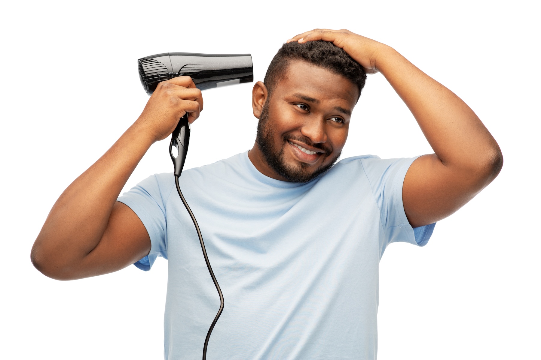 man blow drying hair to add volume