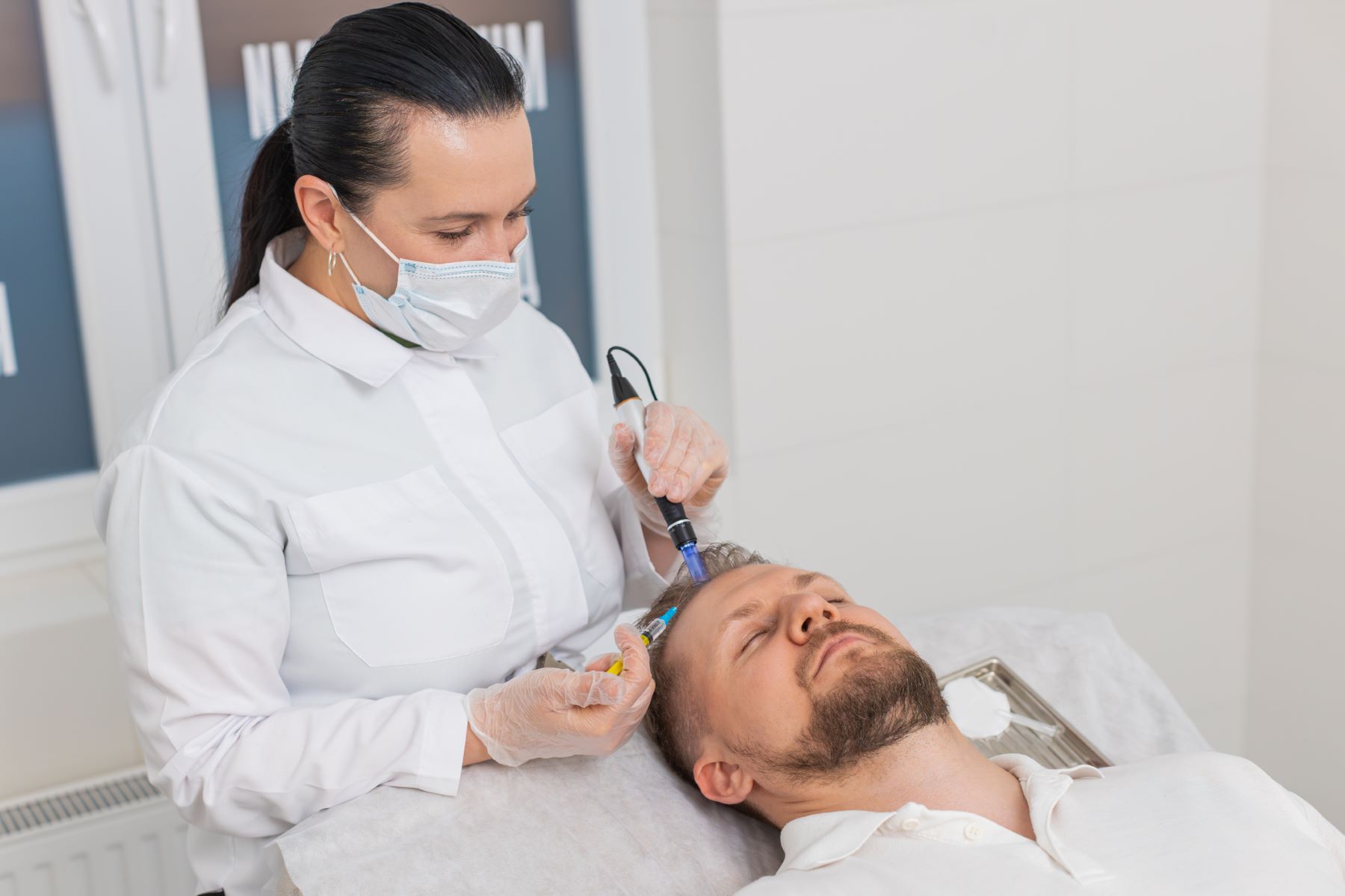 Man getting hair loss treatment