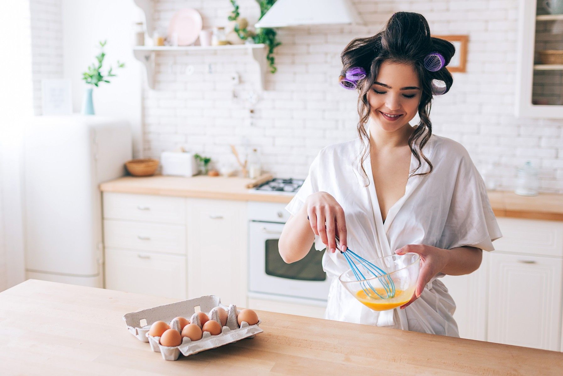 Woman making egg mask for hair
