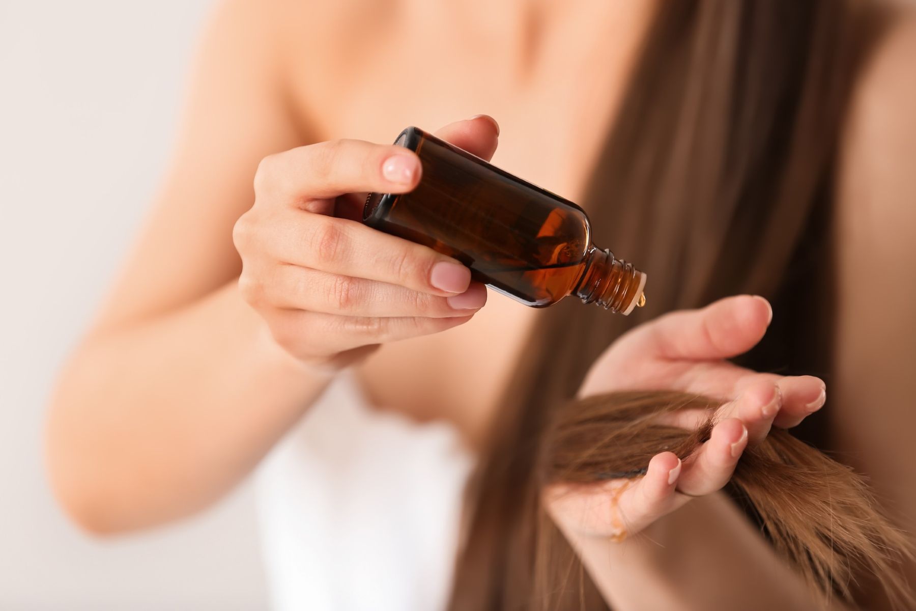 Woman using coconut oil for hair health