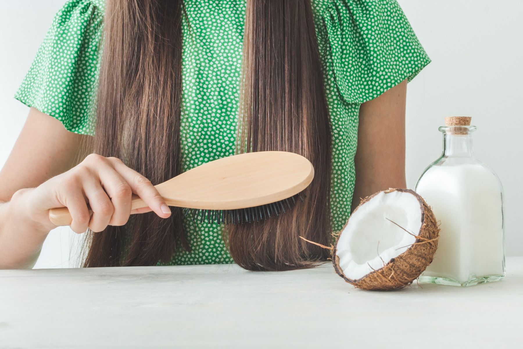 Woman using coconut oil for hair health