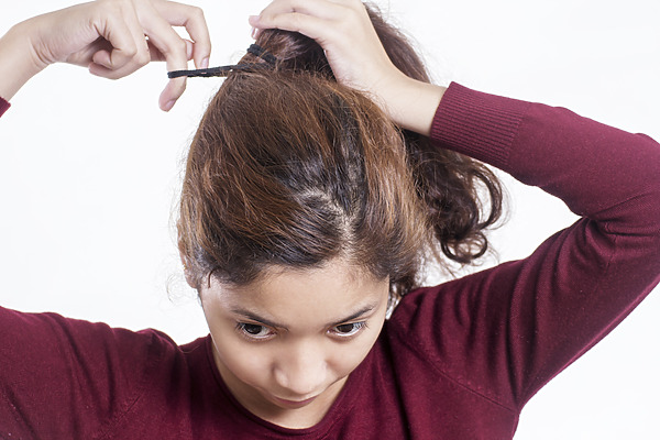 frizzy broken hair on top of head