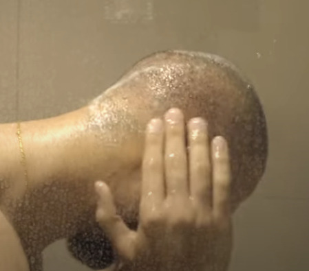 person washing their scalp 10 days post transplant