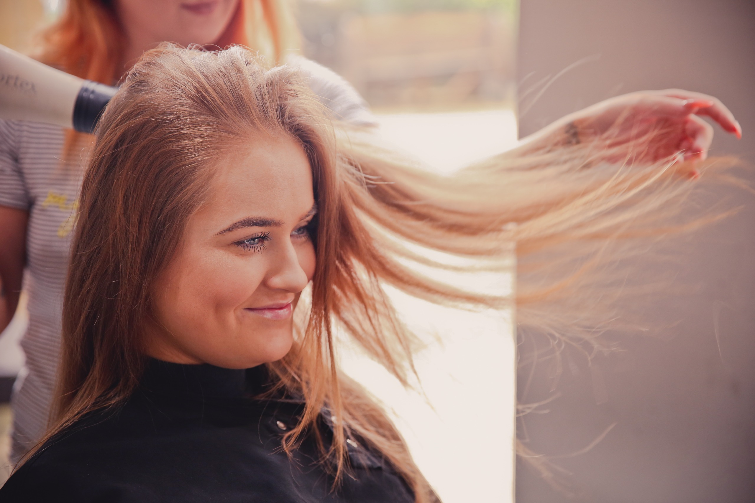woman getting her hair blow-dried